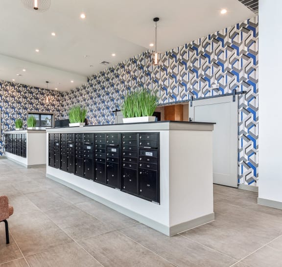 a lobby with chairs and a counter filled with bottles of wine at The Virginia, Seguin, 78155