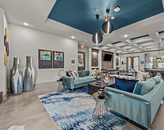 the preserve at ballantyne commons clubhouse with blue couches and chairs