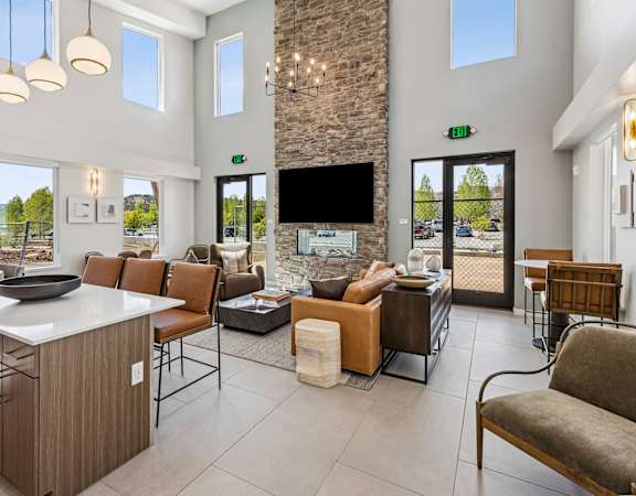 A modern living room with a stone fireplace and a flat screen TV.