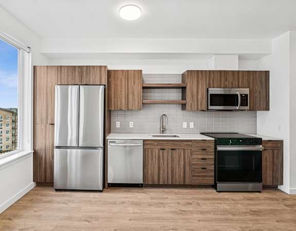 Kitchen with wooden cabinets at Kinline, Beaverton, OR