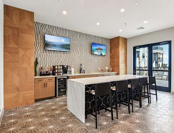 a kitchen with a large island and a bar with chairs at The Virginia, Seguin