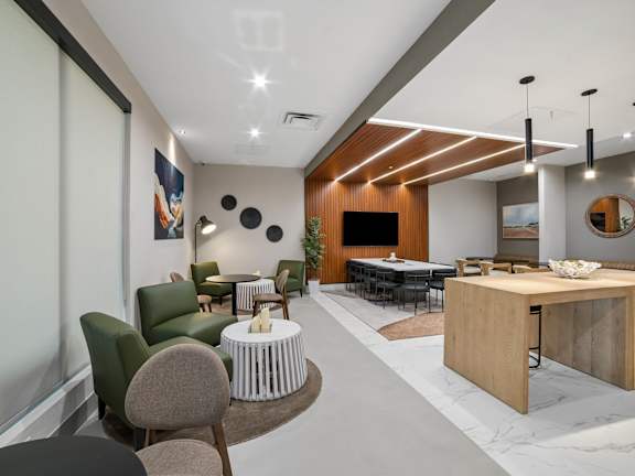 a large fitness room with cardio equipment and large windows