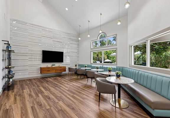 A modern living room with a wooden floor and a flat screen TV.