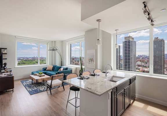 an open living room with a kitchen and a view of the city