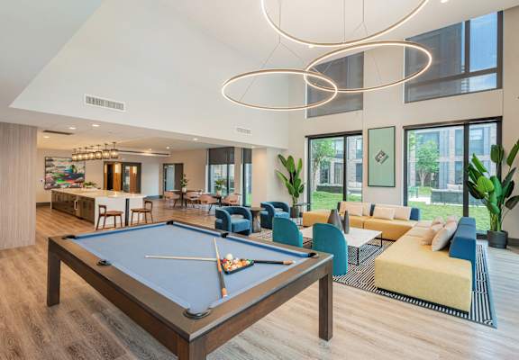 clubhouse with pool table at the preserve at great pond apartments in windsor tx