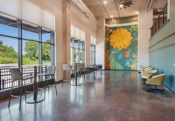 the lobby of a building with a large colorful mural on the wall