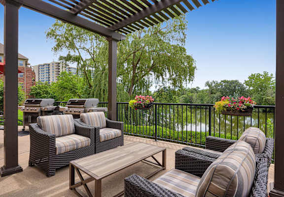 a patio with furniture and a view of a river