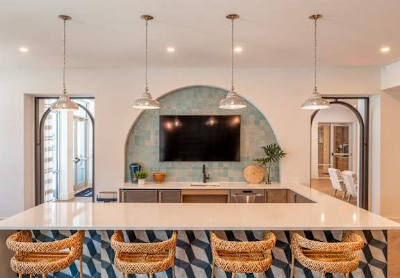 a kitchen with a large island and a television in the back