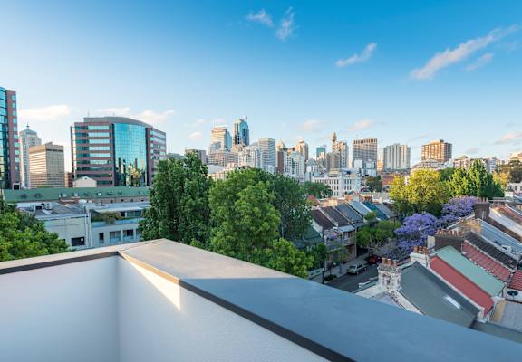 the view of the city from the roof of a building