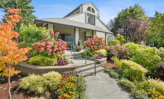 A house with a garden in front of it.