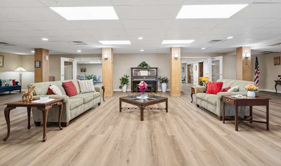 A spacious living room with wooden floors and furniture.