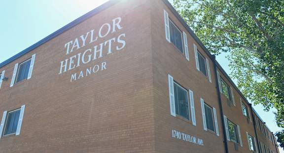 Taylor Heights Manor is a brick building with windows.