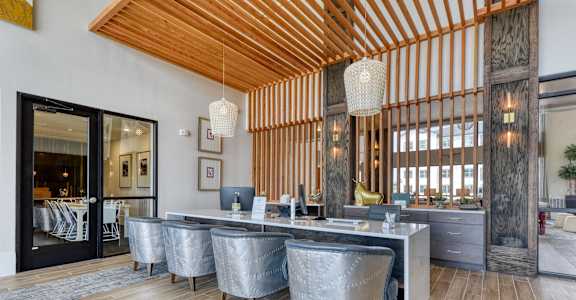 a large dining room with a marble table and chairs