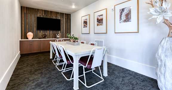 a conference room with a white table and chairs