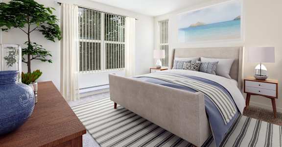 A bedroom with a large bed and a painting of a beach scene on the wall at The Woods Apartments, San Jose, 95136