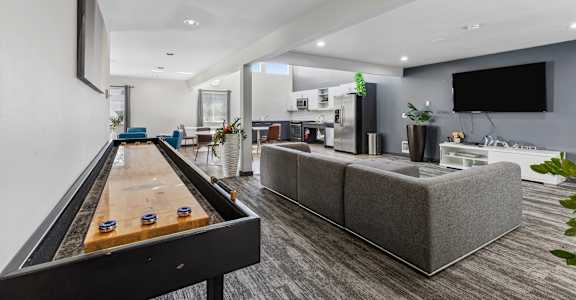 A room with a pool table and a couch.