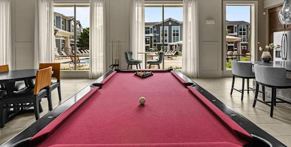 a clubhouse with a pool table and a kitchen with a bar