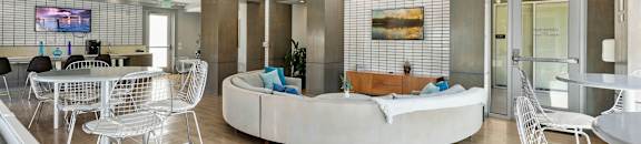 a living room with a couch and tables and chairs