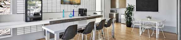 a dining room with a table and chairs in front of a kitchen