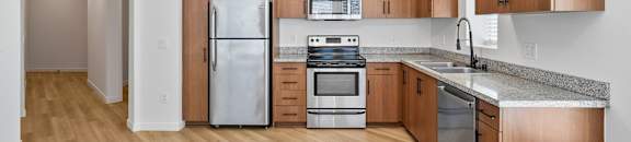 a kitchen with wooden cabinets and stainless steel appliances