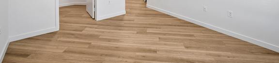 an empty room with white walls and a ceiling fan