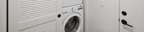a washer and dryer in a laundry room next to a door