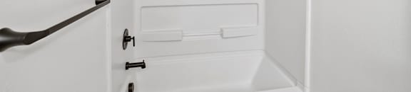 a white bathroom with a white shower and a white door