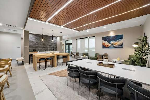 A modern dining room with a wooden table and chairs.