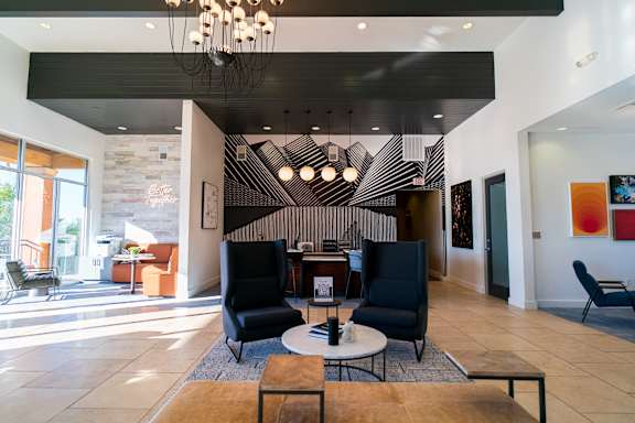 A modern living room with a black and white striped wall.