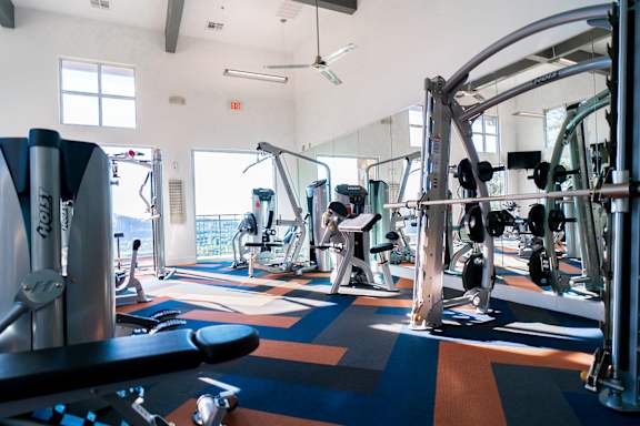 A gym with a variety of equipment including a leg press machine.