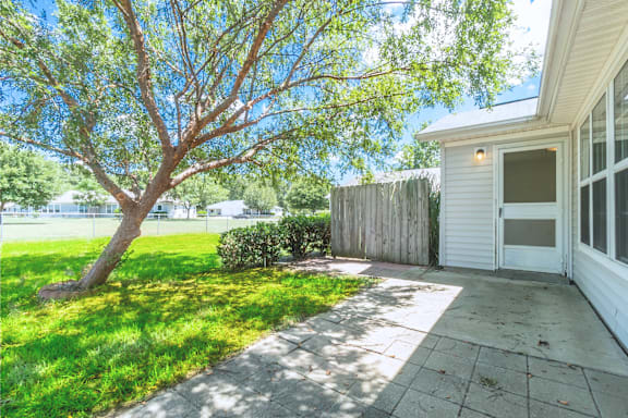 the front yard of a house with a sidewalk and a tree at Huntington Village **, Georgia