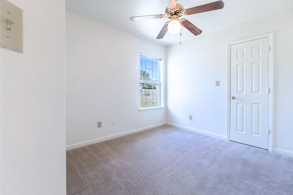 an empty living room with white walls and a ceiling fan at Huntington Village **, Georgia