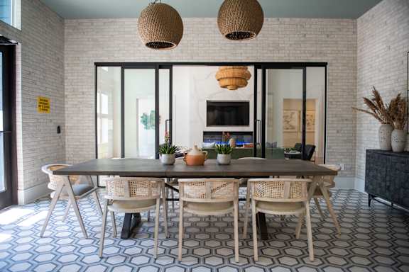 A dining room with a table and chairs.