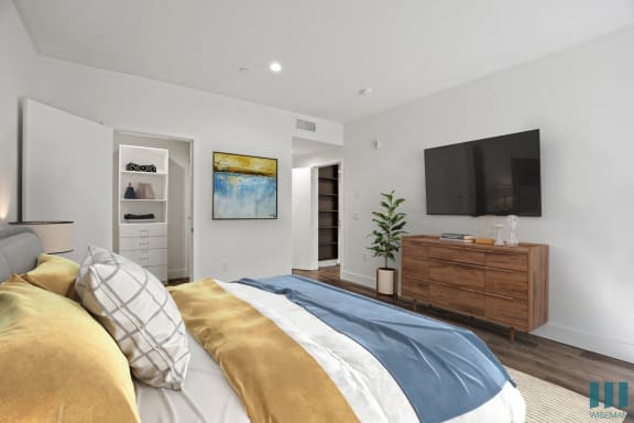 a bedroom with a large bed and a tv