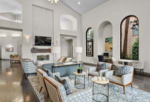 A living room with a grey carpet and furniture.