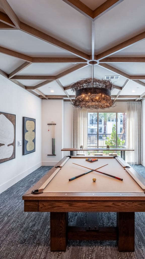 a games room with a pool table and a tv