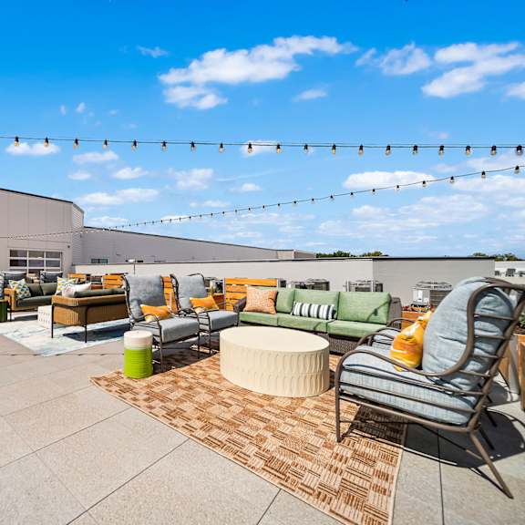A patio with a lot of furniture and a blue sky.