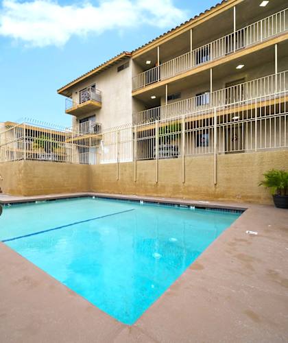 A swimming pool in front of a building.