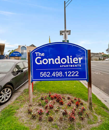 The Gondolier Apartments sign with a phone number on it.