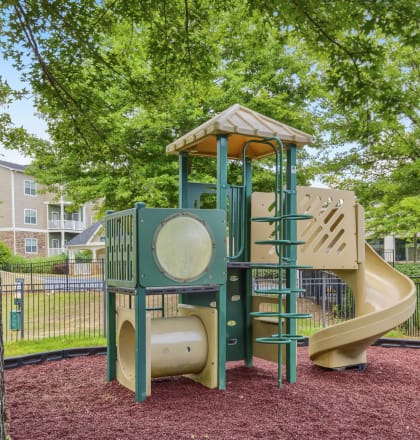 a playground with a jungle gym and a slide