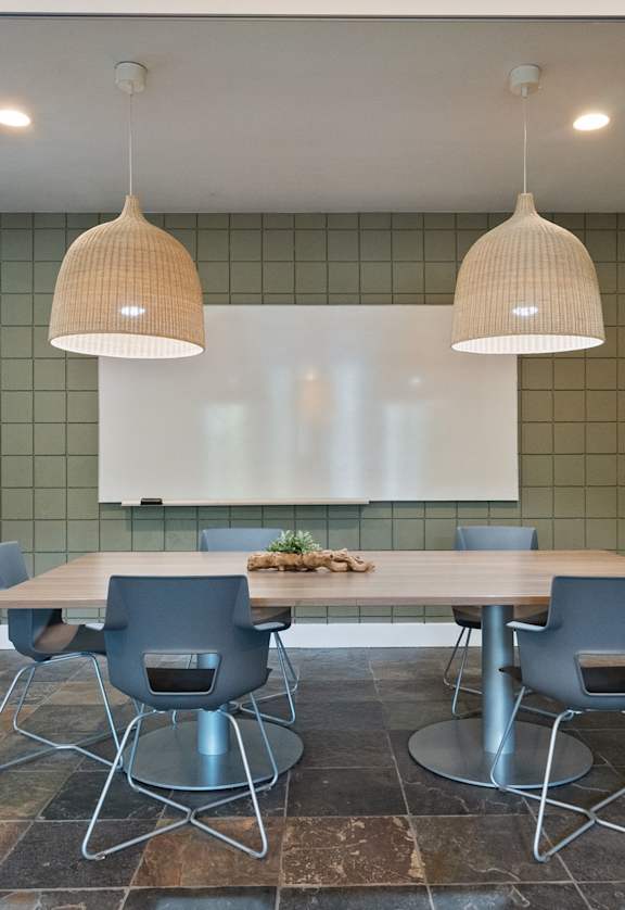 A dining room with a table and chairs.