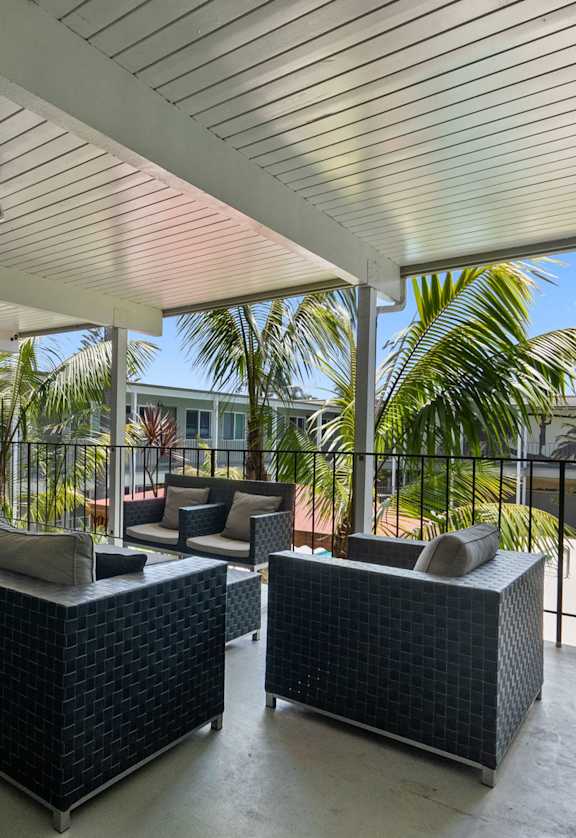 A patio with two couches and a table.