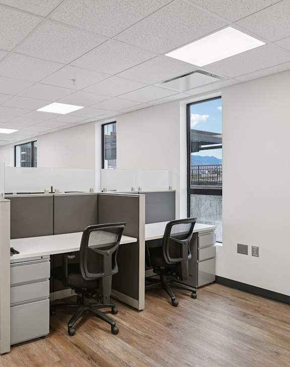 A conference room with a whiteboard and a table with chairs.