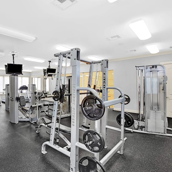 A gym with a variety of equipment including a leg press machine.