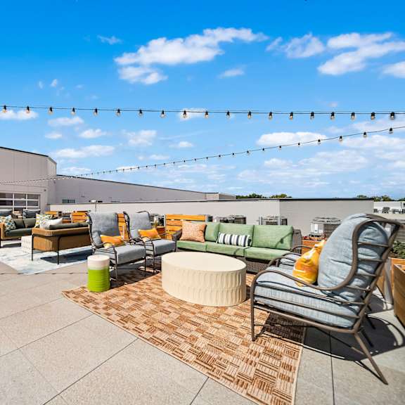 A patio with a lot of furniture and a blue sky.