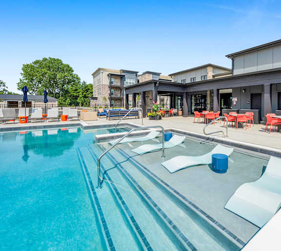 A large outdoor swimming pool with a white border and a white edge.