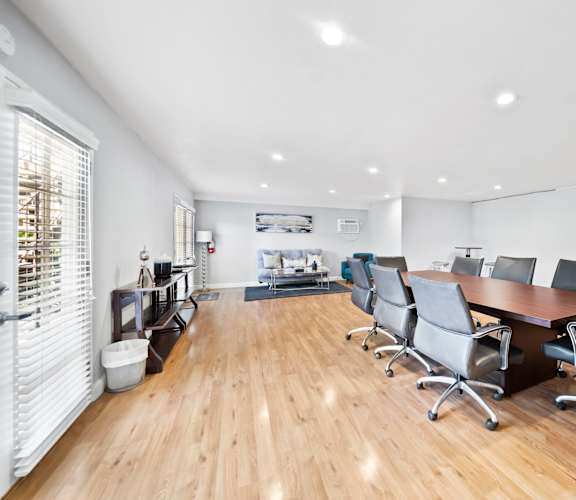 A conference room with a long table and chairs.