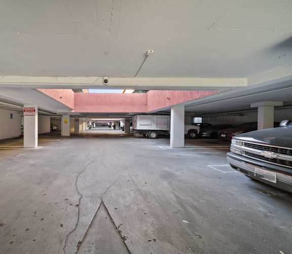 A Chevy truck is parked in a large, empty parking garage.