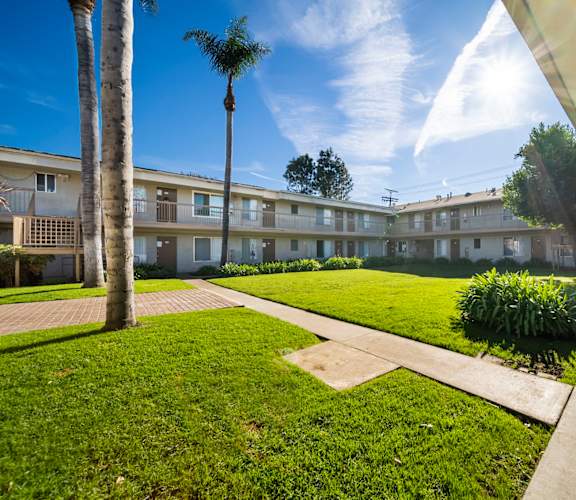 A sunny day at the apartment complex with a clear blue sky.
