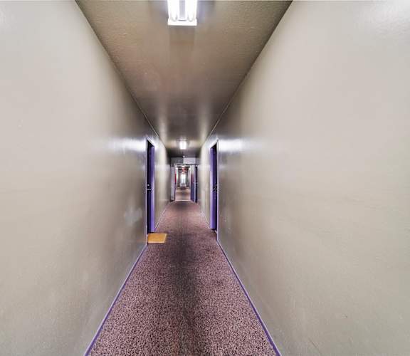 A long hallway with a purple line on the floor.